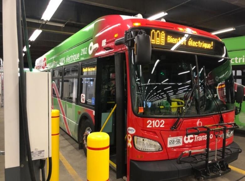 A photo of a new electric OC Transpo bus sits in a garage during a photo op Nov. 26, 2021.