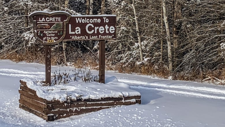 Wooden welcome sign with the words La Crete on it.