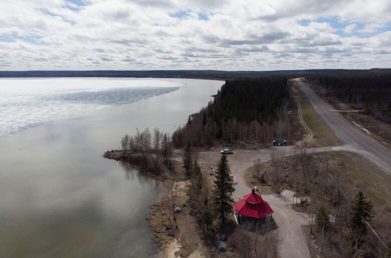 A campground along a highway. Lake, trees.