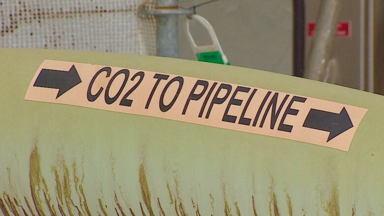 A green pipeline is shown with a yellow sticker saying 'CO2 to pipeline'