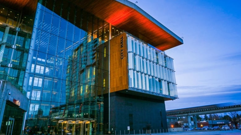 A photo of Surrey's city hall at dusk.