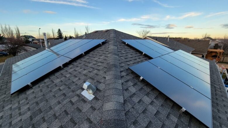 Solar panels on a roof at sunset 