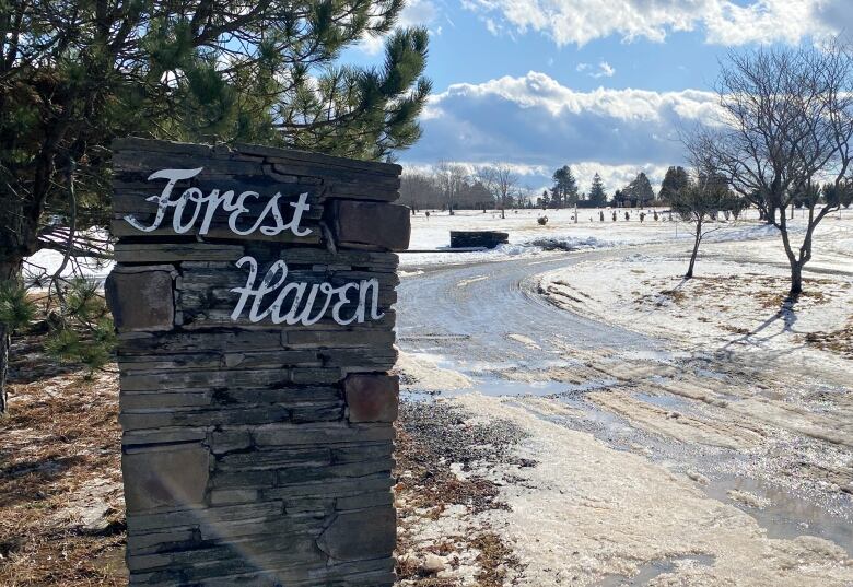 A stone marker is at the entrance to Forest Haven funeral home.