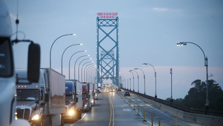 Commercial trucks and passenger vehicles drive across Ambassador Bridge on the Canada-U.S. border in Windsor, Ontario, Canada, on Thursday, Aug. 9, 2018. The Ambassador Bridge connects Canada to USA, from Windsor to Detroit and facilitates over 30% of all Canada-US road trade. Photographer: Cole Burston/Bloomberg