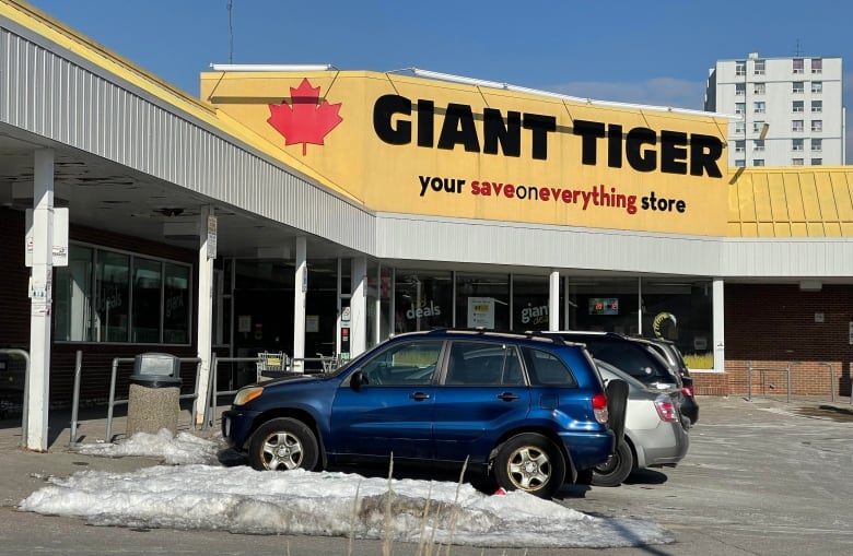 Cars are parked outside a store.