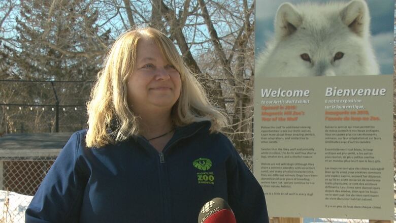 Jill Marvin in front of a sign talking to reporters.