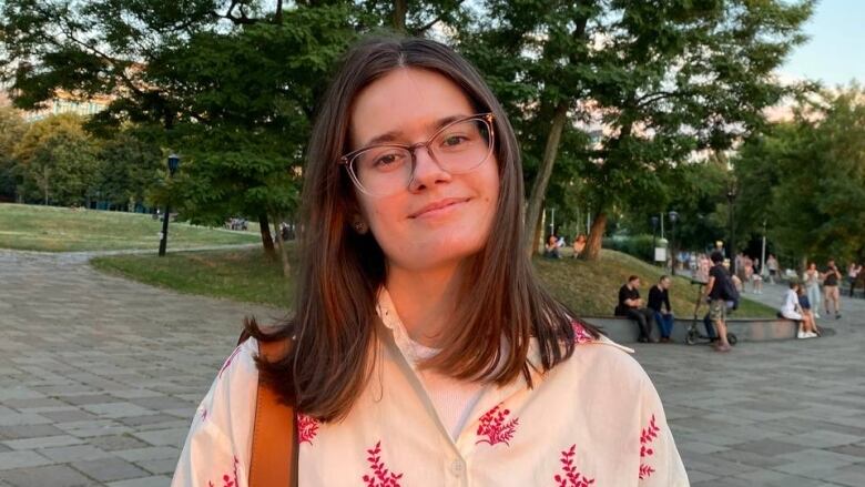 Photo of woman in floral shirt.