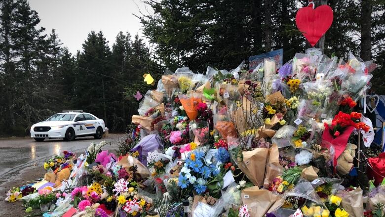 An RCMP car is seen near a memorial display in Portapique following the mass shooting in April 2020.