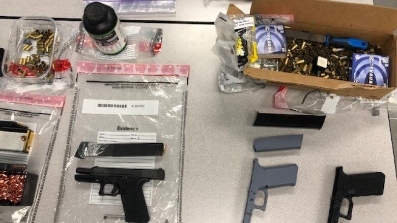 Confiscated illegal items are put on display by police including 3D printed guns.