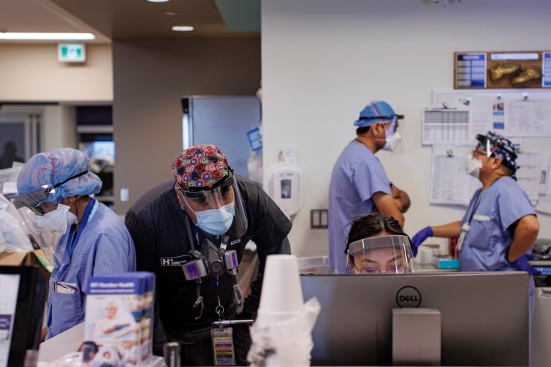 A bustling nursing station in the Humber River Hospital intensive care unit, in Toronto, is pictured on Jan. 25, 2022.