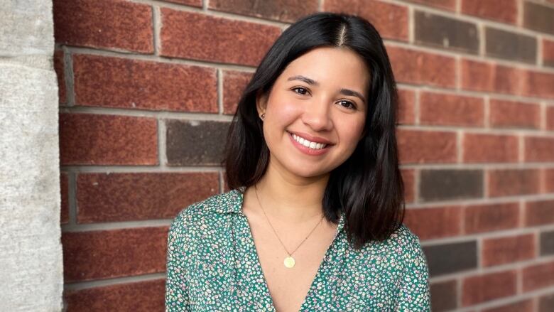 A portrait of a woman smiling at the camera.