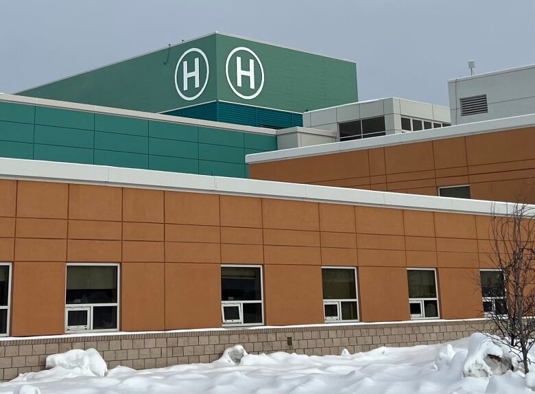 A hospital building exterior on a grey winter day