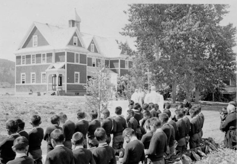 Children gathered in a group outside St. Joseph's Mission Residential School in an old undated photo.