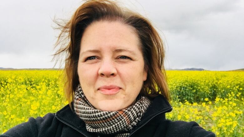 A woman standing in a field.