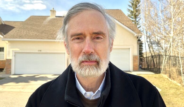 A close-up shot of a man in a dark jacket.