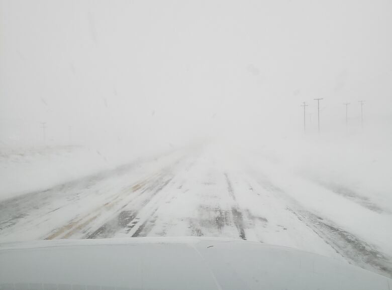 View of whiteout as seen through the windshield of a vehicle.