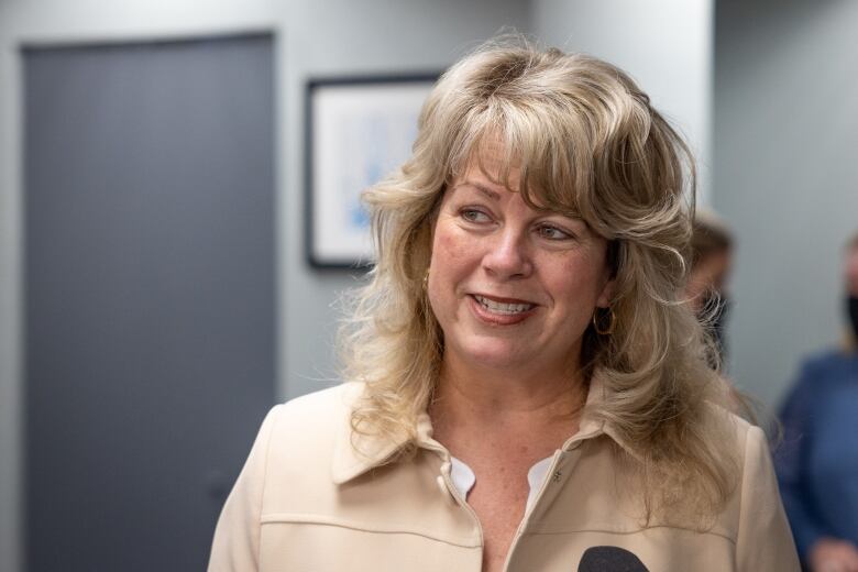 A woman is shown looking to the right and smiling. Cynthia Carroll is executive director of Autism Nova Scotia.