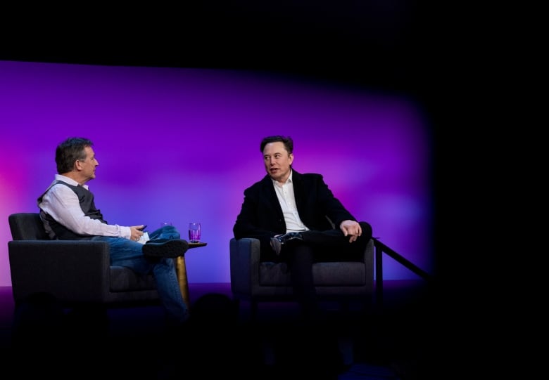 TED CEO Chris Anderson, left, interviews Elon Musk during the last TED 2022 session in Vancouver on April 14, 2022.