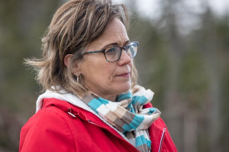 A woman in a scarf and a red jacket