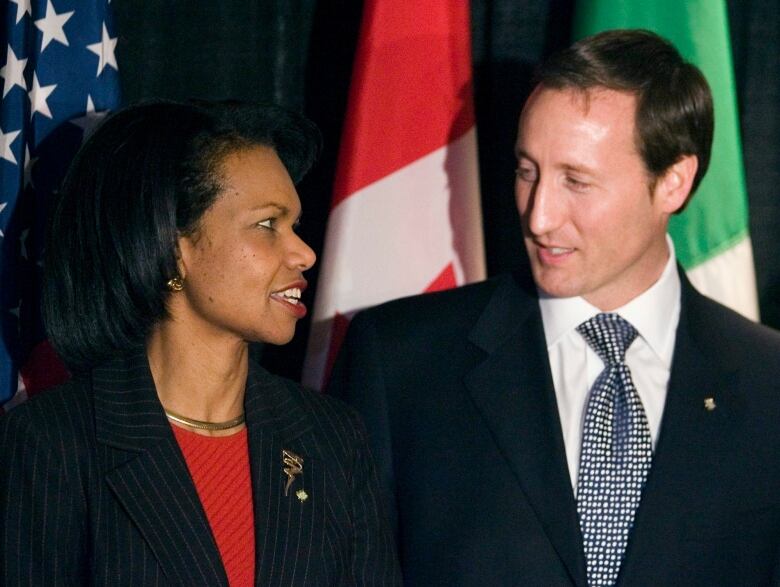 Condoleezza Rice and Peter MacKay shown speaking to one another