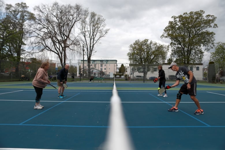 Four people on a court. 