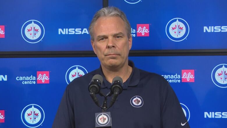 A man speaks at a podium.