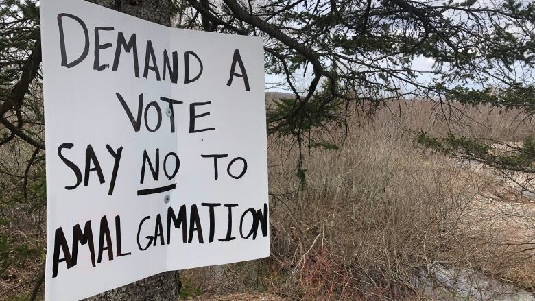 A sign on a back road in Antigonish County calls for a public vote on a potential merger with the town. 