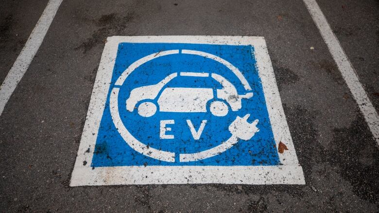 An EV charging sign on a parking space. 