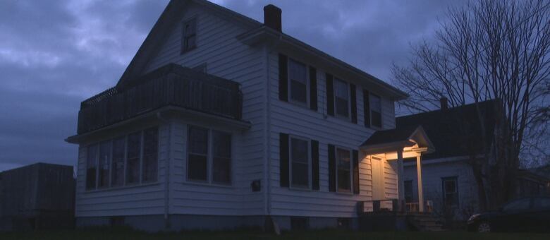 A single light illuminates the house where Summerside police shot Jeremy Stephens in May 2018.