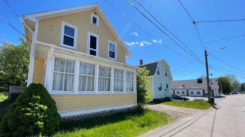 House with fading yellow paint and white trim.