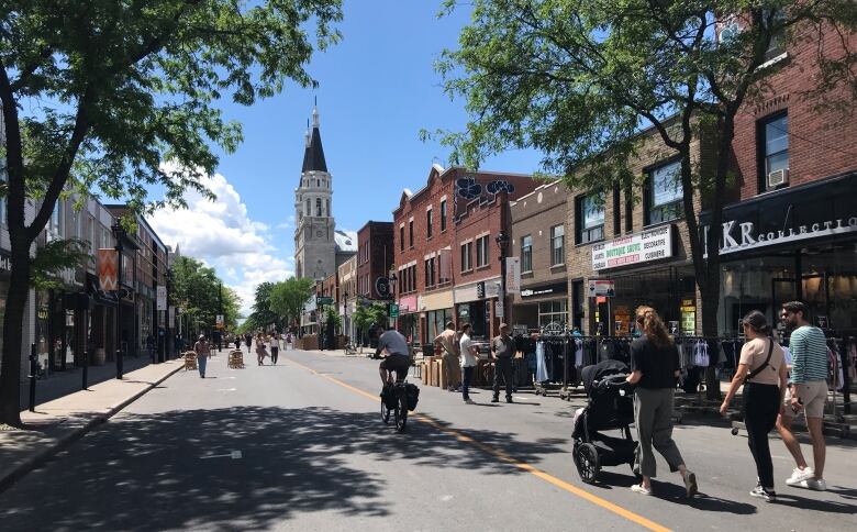 People are in the middle of the street. 