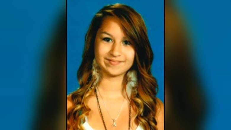 Amanda Todd smiles for a picture. She is wearing a white top.