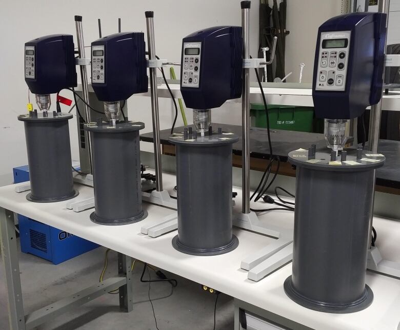 Four one-litre tanks are on a table in a lab at Sudbury's Cambrian College.