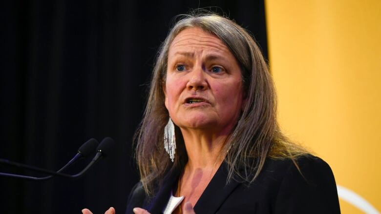 woman speaking at podium