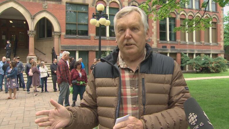 Ken Stannix standing outside the Fredericton courthouse.