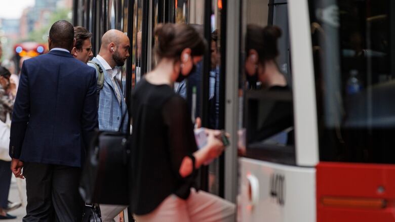 Riders step into a streetcar