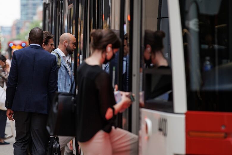 Riders step into a streetcar