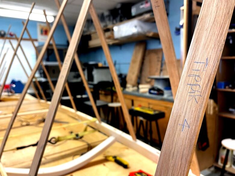 A tight shot of the wooden pieces that compose the frame of a kayak. 