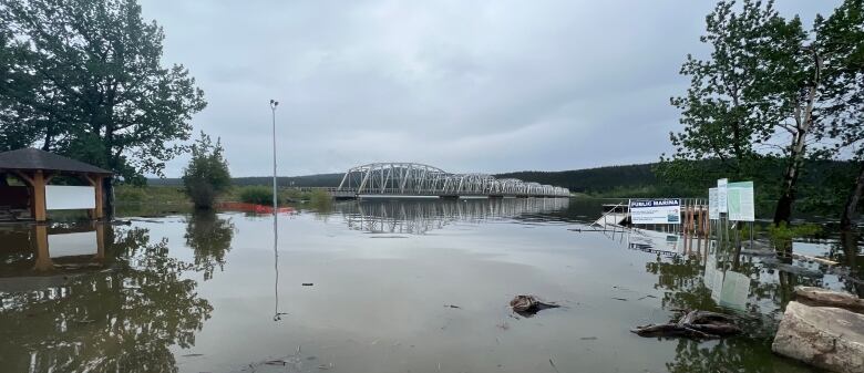 A bridge crosses a calm river.