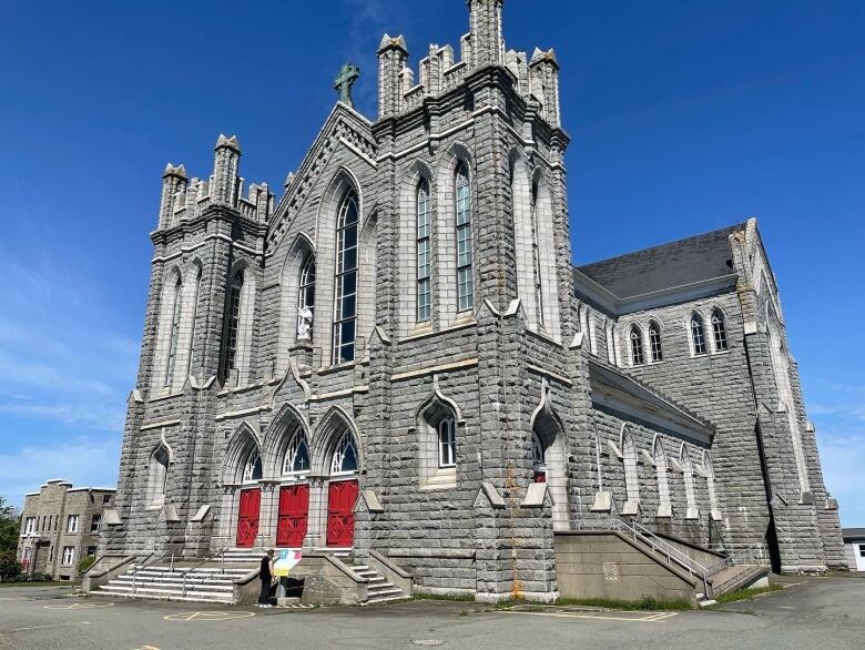 An imposing granite church building in Romanesque style. 