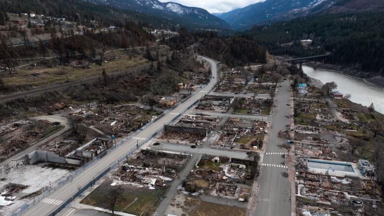 Ariel shot of a street where all the buildings have burned to the ground.  