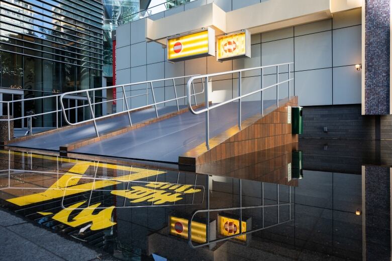 Two bright yellow no reentry signs hang above two ramps.