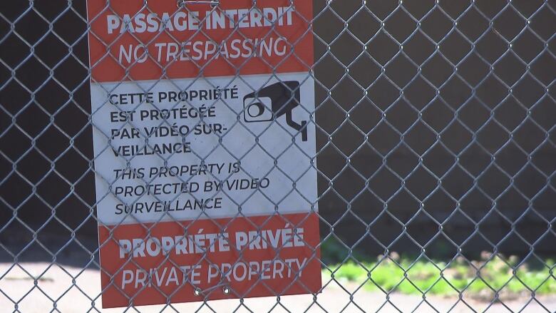 A sign on a fence calls no trespassing on private property, which is under video surveillance. 