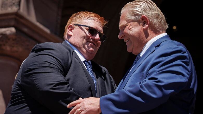 Graydon Smith shakes hands with Premier Doug Ford, 