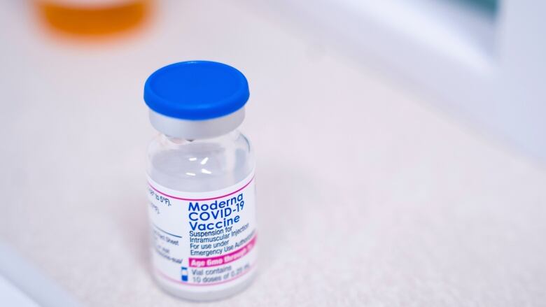 A vial of the Moderna COVID-19 vaccination for children under five sits on a counter.