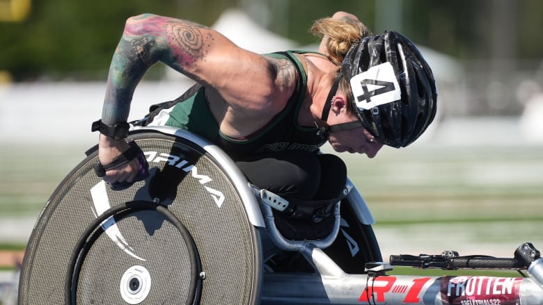 A female wheelchair racer on a track.