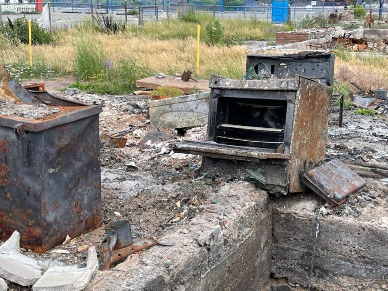 A charred oven sits among a pile of rubble a year after a wildfire destroyed Lytton, B.C.