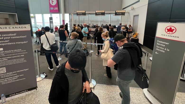 A lineup at the Pearson airport customer service desk after many cancellations.