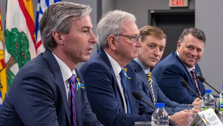 Four men in suits. 