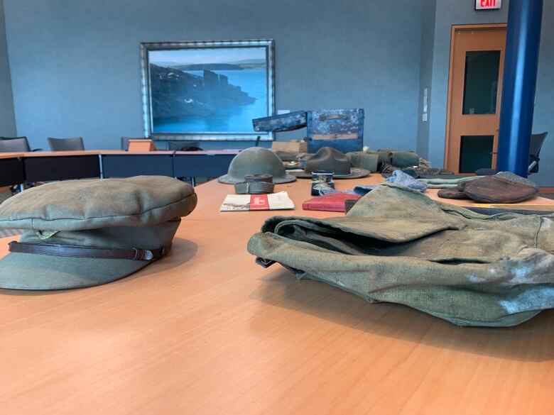 A military hat and uniform laid out on a table.